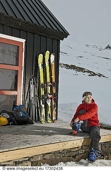 Woman getting ready for ski touring at ski cottage in Iceland