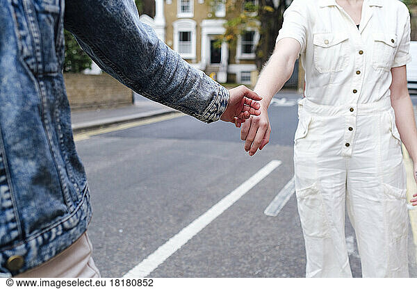 Woman giving hand to friend on street