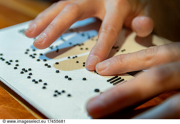 Woman hands reading braille text