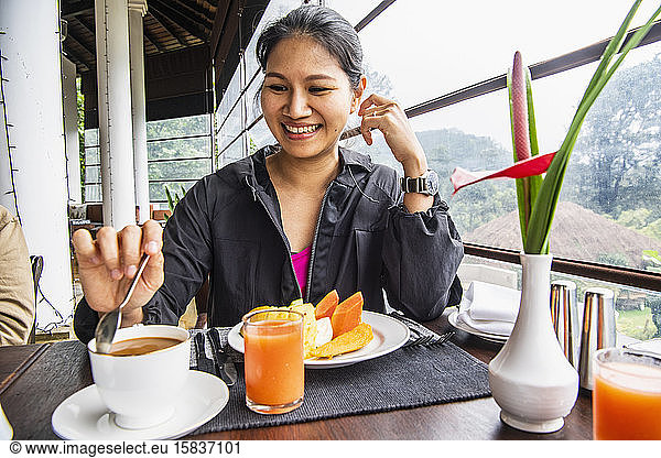 woman having a healthy breakfast with tropical fruit
