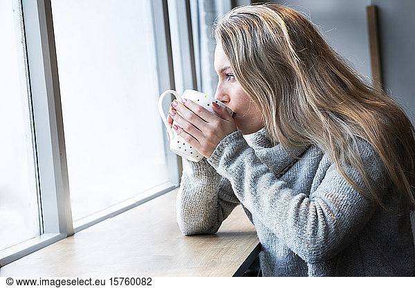 Woman having tea in cafe