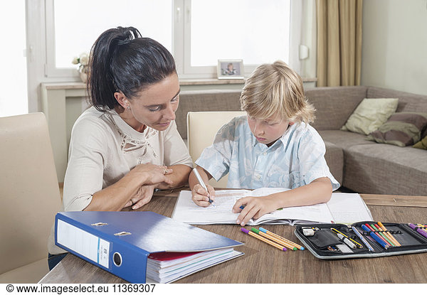 Woman helping her son with his homework