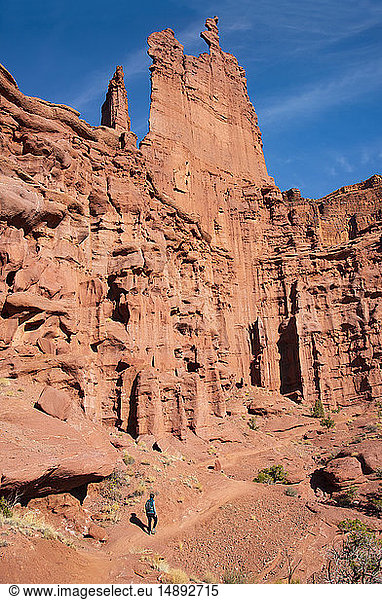 Woman hiking by Fishers Tower in Moab  Utah  USA
