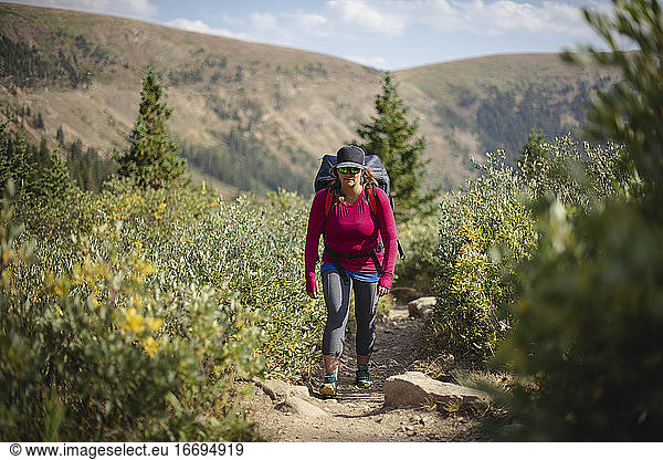 Woman hiking on mountain during summer