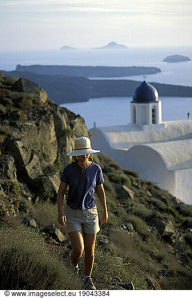 Woman hiking seaside trail  Santorini  Greece