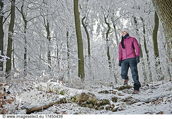 woman hiking through frosty German forest in Lower Saxony