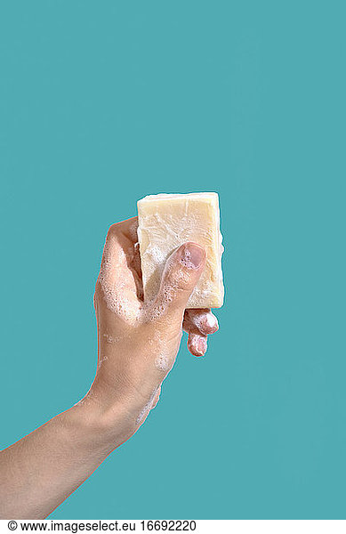 Woman hold soap with foam