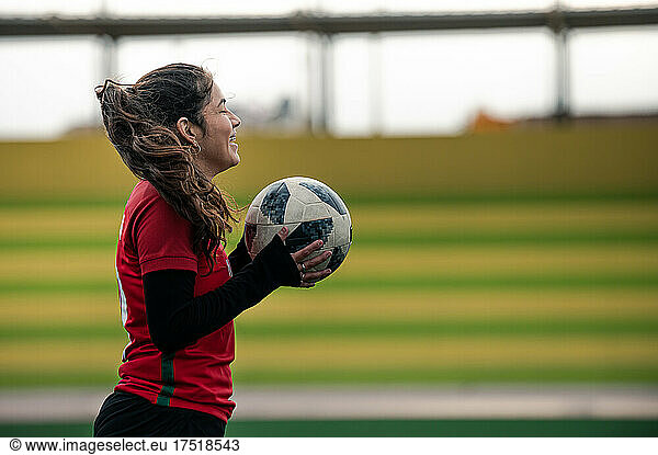 Woman holding a soccer ball in her hand
