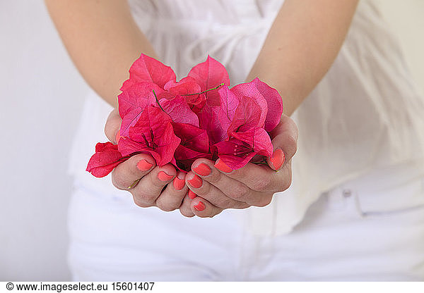 Woman holding flower petals in her hands