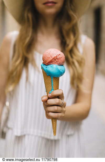 Woman holding melting ice cream cone