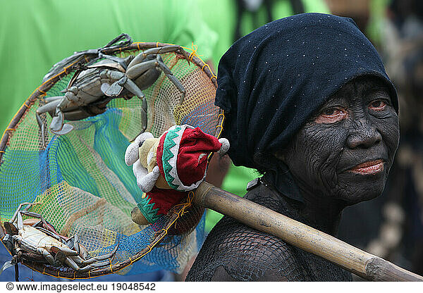 Woman holding offerings at Ati Atihan festival  Ibajay.