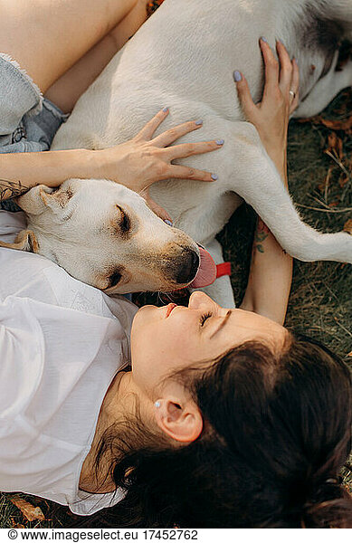 Woman hugging her Labrador. Lifestyles and pet care concept.