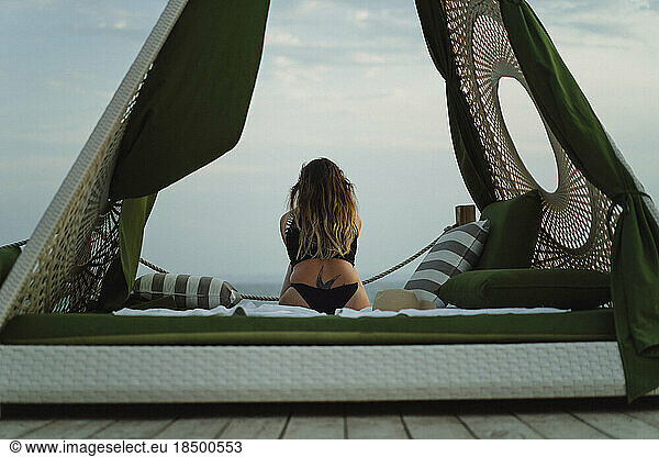 Woman in a pavilion on the seashore  vacation.