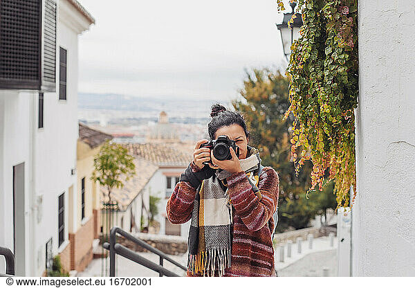 Woman in a sweater with a camera in Granada  Spain