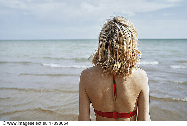 Woman in blond hair looking at sea
