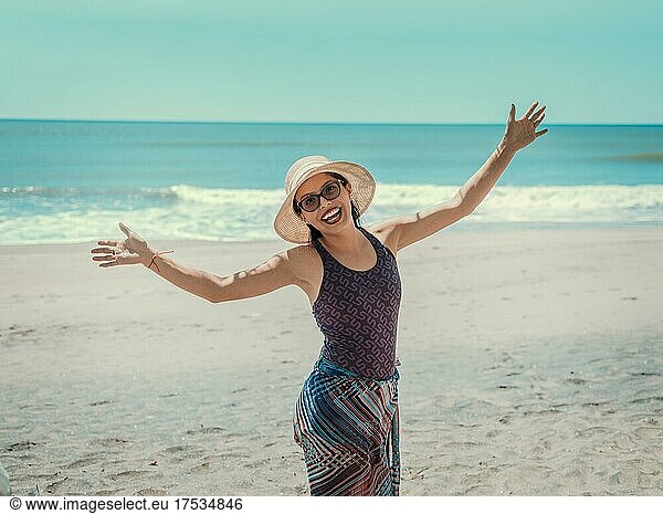 Woman in hat happy on the beach  happy pretty young woman on vacation  vacation concept