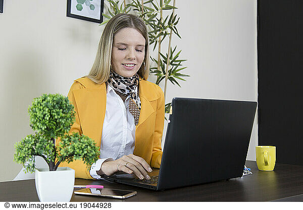 Woman in office using laptop