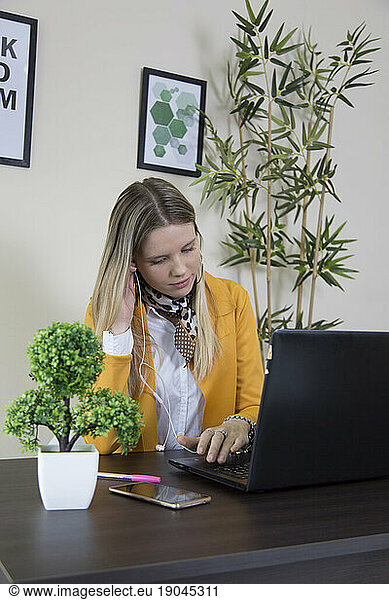 Woman in office using laptop