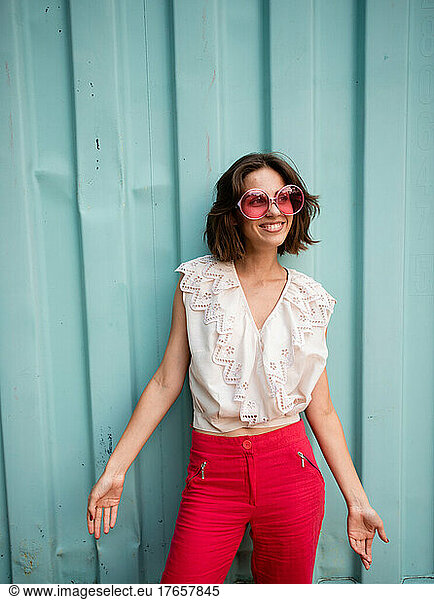 woman in pink sunglasses smiles
