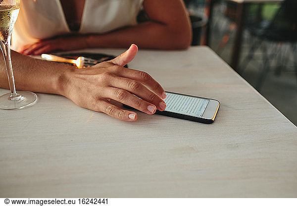 Woman in restaurant using cell phone