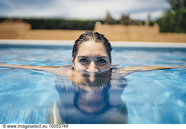 Woman in swimming pool looking up