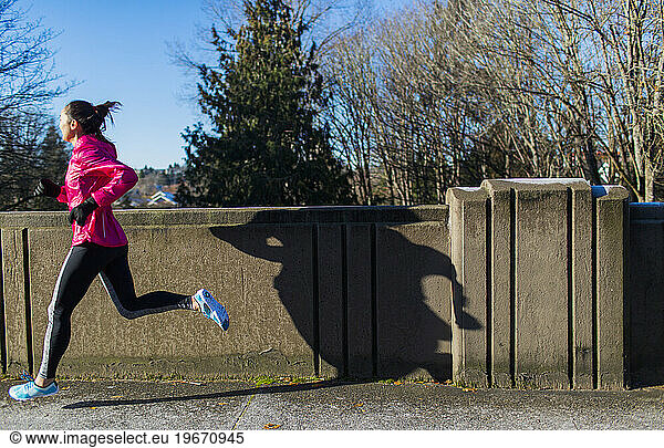 Woman jogging across bridge  Seattle  Washington  USA