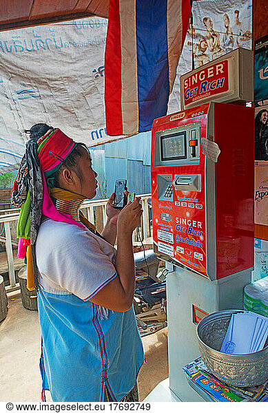 Woman Kayan reloading her smartphone N.W. Thailande