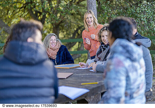 Woman laughing and talking with friends at park