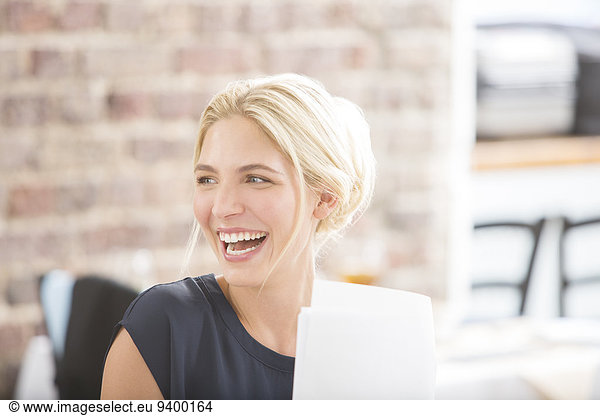 Woman laughing in office
