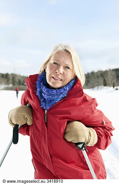 Woman leaning against her ski sticks