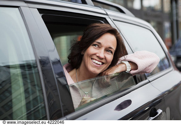 Woman leaning out from car window