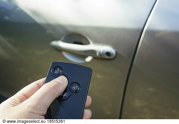 Woman locking car with card key