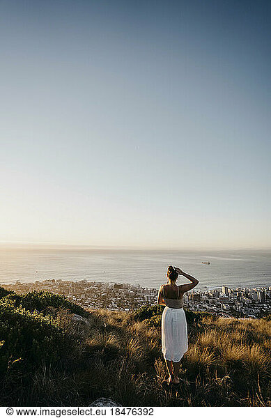 Woman looking at city from Signal Hill on weekend