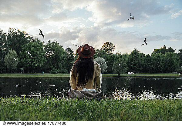 Woman looking at lake sitting in park