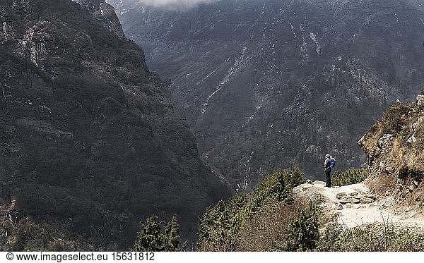 Woman looking at Namche Bazaar  Himalayas  Solo Khumbu  Nepal