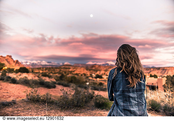 Woman looking at sunset in the desert  Moab  Utah
