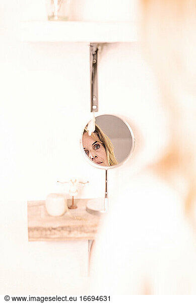 woman looking in a dressing table mirror