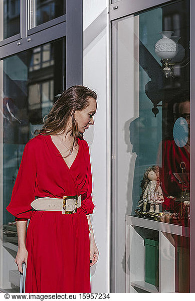 Woman looking in shop window in the city
