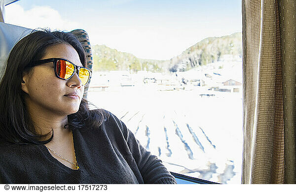 woman looking out of the window during train ride to Takayama