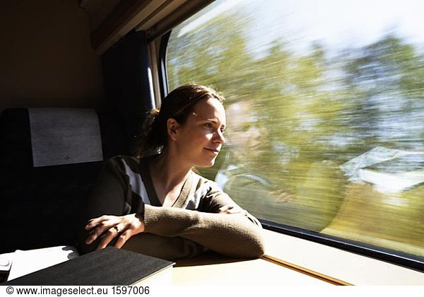 Woman looking out the window from a train.