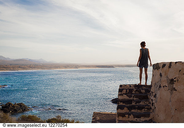 Woman looking out to sea  Corralejo  Fuerteventura  Canary Islands
