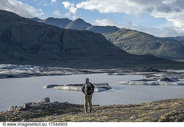 Woman looking over glacial lake  geology trail to Skalafellsjökull  Hornafjörður  Austurland  Iceland  Europe