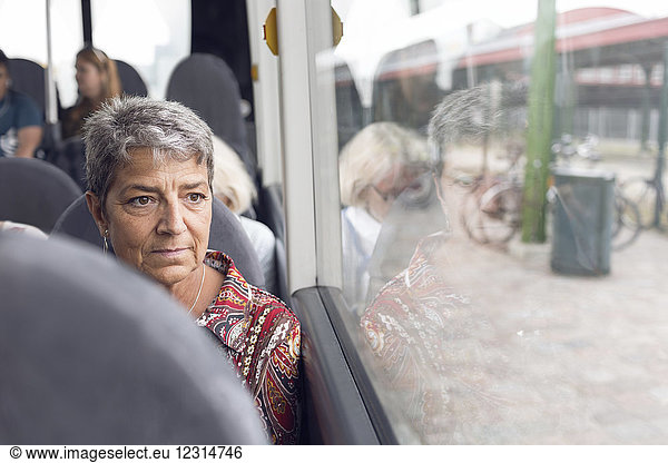 Woman looking through bus window