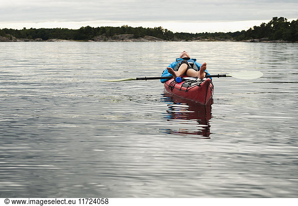 Woman lying on kayak