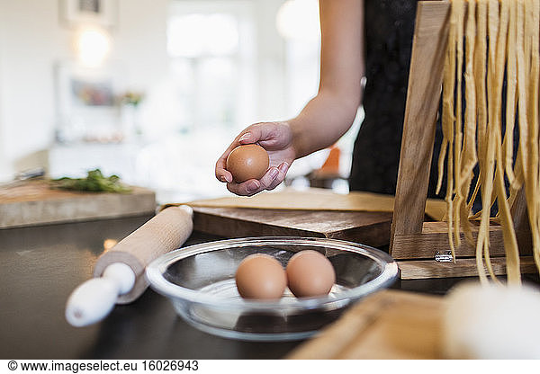 Woman making fresh homemade pasta in kitchen