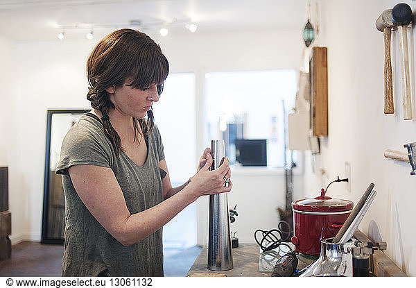 Woman making jewelry in workshop