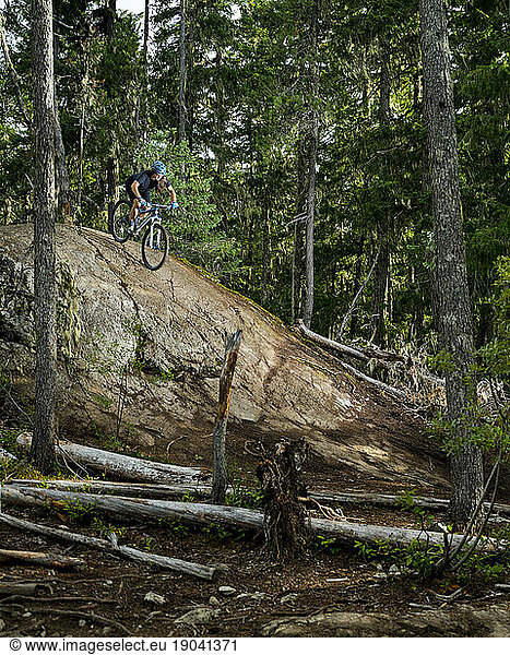 Woman mountain biking in forest  Lost Lake Trails  Whistler  British Columbia Ã¢â?¬Â Canada