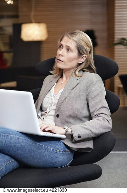 Woman on chair with laptop