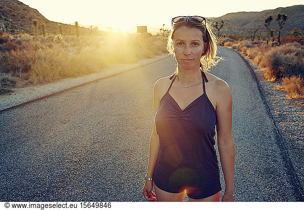 Woman on country road at sunset  Joshua Tree  California  USA
