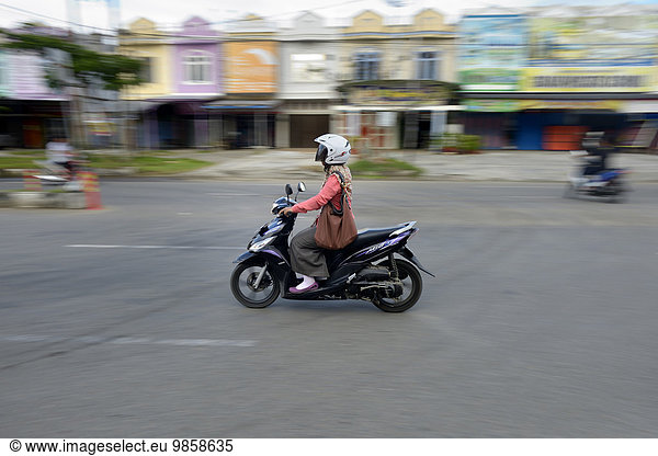 Woman on moped  Banda Aceh  Indonesia  Asia